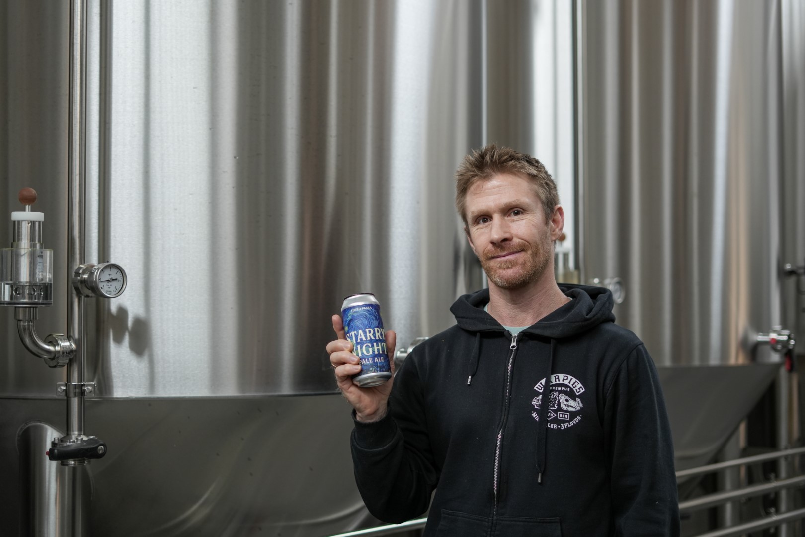 Bryan France mit dem Spendenbier in der Yankee & Kraut  Brauerei am Auwaldsee